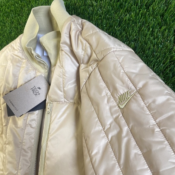NWT Woman Nike Therma-FIT Tech Pack Long Puffer Jacket Gold Sz S Reg $200
